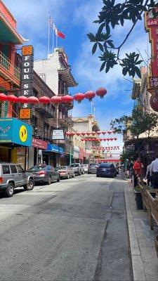 Between the red and blue awnings on the left