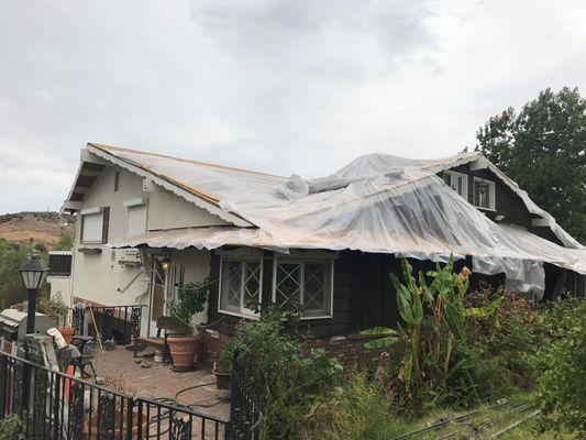 The plastic they put on the roof blew off the back of the house during a storm.