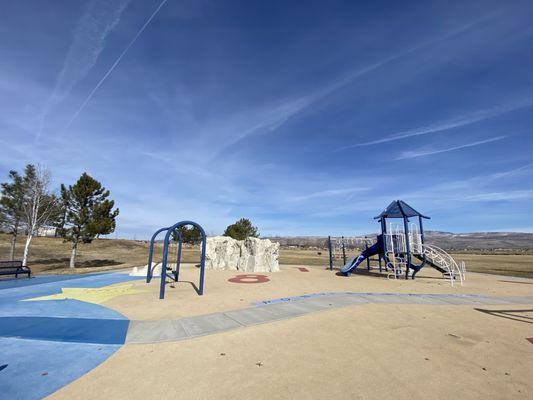 Swings, climbing rock and playground.