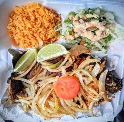 Fried whole fish with rice and salad