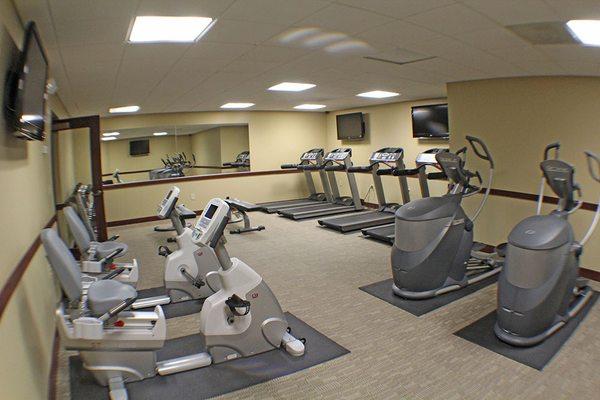 Fitness center with flat screen TV's, cardio machines and free weights.