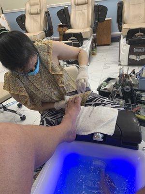 Lady doing a good job on my feet, it's really hard for me to do, feel so good after they do it