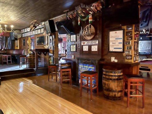 View from entrance opposite the bar, seating area to left, bar to right, pool tables in far section