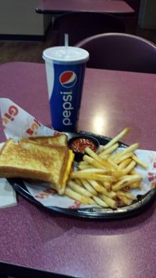 Grilled cheese, fries and a fountain drink.