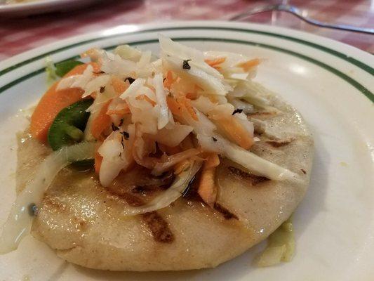 Pupusa topped with cabbage and jalapeno