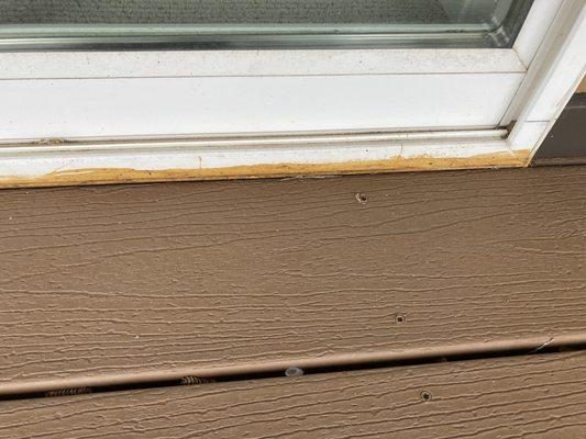 Brown stain on base of white patio door