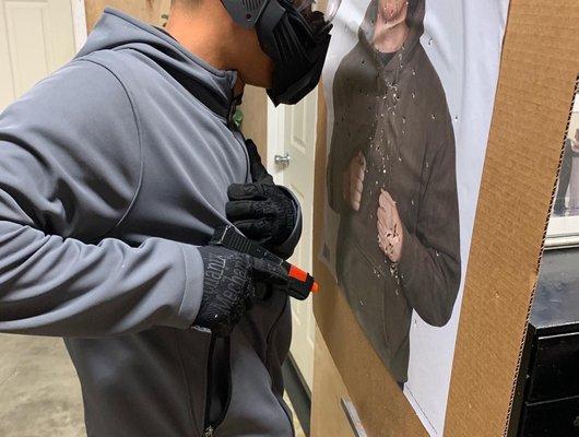 Student in practicing extreme close quarters shooting in safe environment.