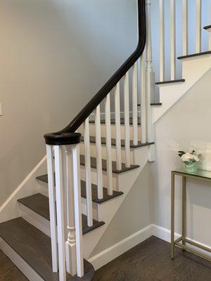 Sanded and stained all the stairs, replaced the old balusters with modern square ones, painted everything white, and stained the top dark 3