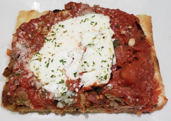 Eggplant Rollatini slice: seasoned ricotta, eggplant and plum tomatoes atop a crispy crust.  Each slice is a flavorful meal!