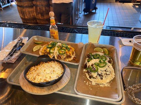 Steak and chicken tacos with Mexican corn