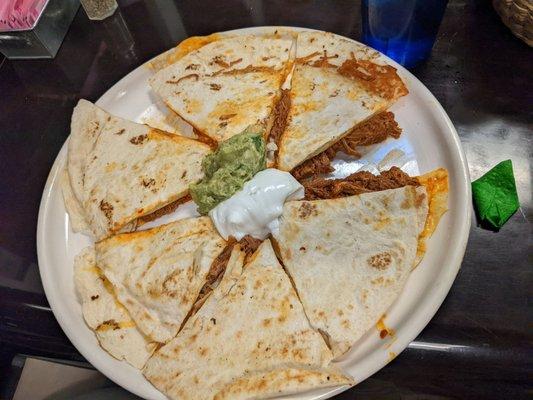 Quesadilla with beef, guacamole, and sour cream. Delicious!