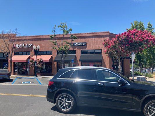 View from across the street. Plenty of free parking as there are two designated Handicap Spots immediately in front of T-Mobile.