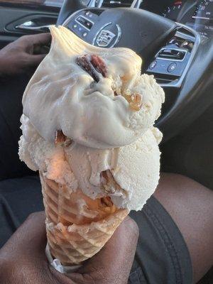 Butter pecan ice cream in a regular waffle cone