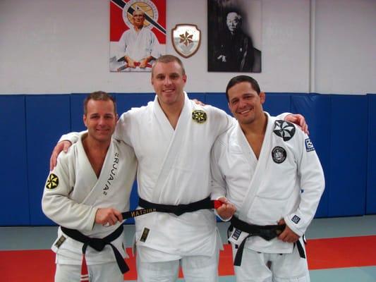 Professor Kris earning his black belt from Master Saulo Ribeiro. With Professor & Ribeiro Jiu Jitsu Director Chris Blanke.