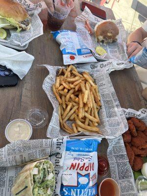 Chicken Ceasar wrap, buffalo chicken bites, burger, jerk chicken burger, and fries