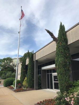 National Ensign, Coast Guard Ensign, POW/MIA Flag flying proudly outside the Federal Building