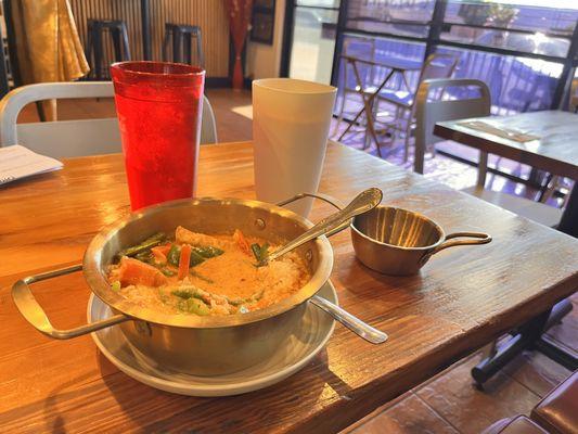 A very delicious panang curry with green bean bell pepper and fried tofu and Thai iced tea!