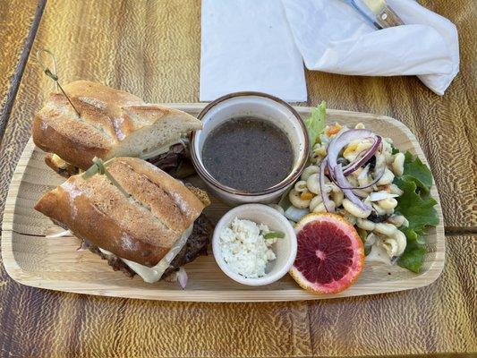 Tri tip French dip with pasta salad, au jus, and horseradish sauce