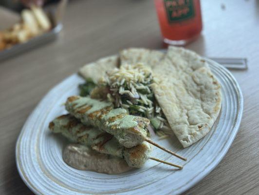 Chicken skewer plate and non alcoholic Cranberry beverage