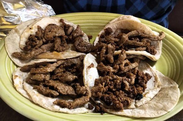 Mexican tacos - corn tortilla, steak, and chorizo. Onions and cilantro on side.