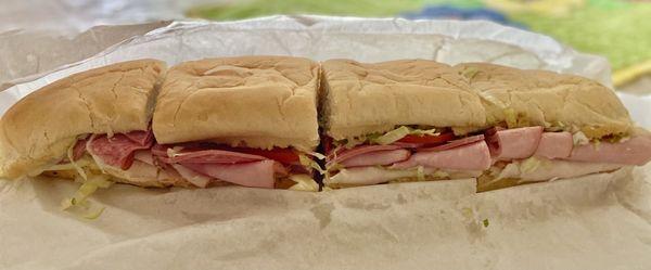 Super Sub with Turkey, Ham, Salami, Provolone cheese, lettuce, tomato.  16 inches, cut into fourths.