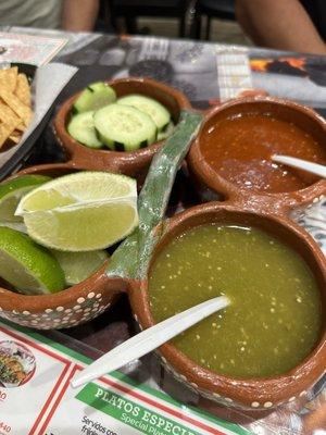 Complimentary salsas, fresh cut cucumber and radishes and limes