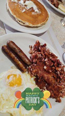 Corned beef hash , eggs ,sausage, and pancakes