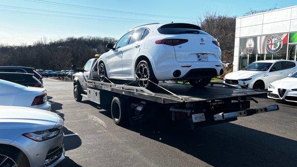 Alfa Romeo Stelvio loaded on my flat bed, ready to be taken home.