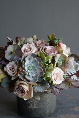 "The Ines" - a moody arrangement featuring succulents and roses.