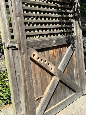 Old gate door repurposed to fill old gate post hinge areas.