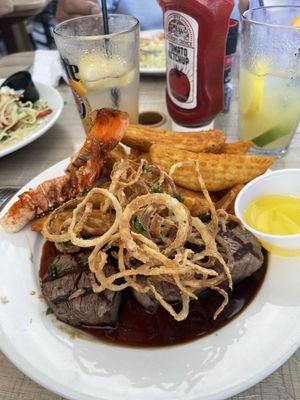 While this surf and turf special looks impressive don't be fooled. There were tiny steak medallions under all those fries and onion straws.