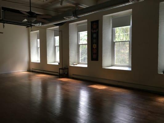 A look inside the large studio space with hardwood floors and large windows that look out to nature and the Cuyahoga river!