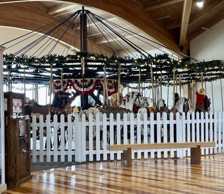 The eating area is open to the walkway and this carousel is across the walkway.