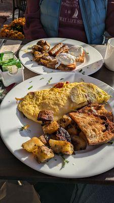 Omelette in front; poached eggs at rear