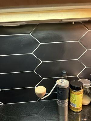 Damaged tile with shiny product on top to "fix" it