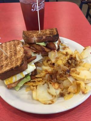 Breakfast Club Sandwich with home fries on the side.