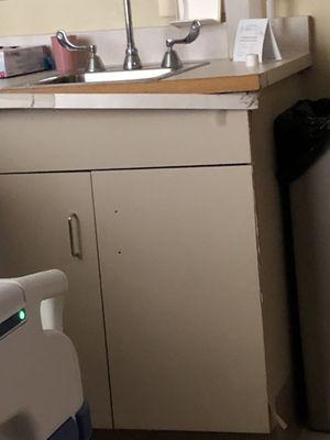 Cabinet in patient room is coming apart.