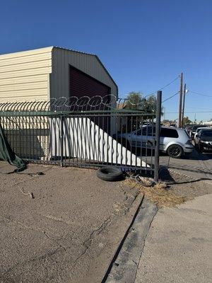 Entrance to this lot with old tires and barbed wire. Not safe.