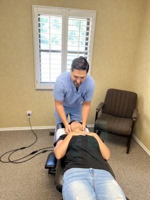 Dr. Johnson manually adjusting a Patient's Neck.