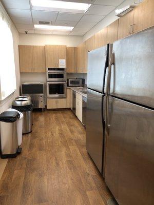 Behind the bar area- to prepare food or keep refrigerated.  They have an ice maker, oven, microwave, sink. They don't have a stove top.