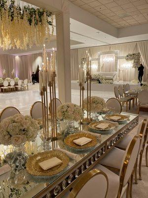 Gold chargers on our crystal chandelier tables.