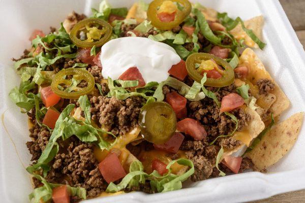 Loaded Nachos:
 Ground Meat,
 Blended Cheese,
 Lettuce,
 Tomatoes,
 Sour Cream,
 Jalapenos