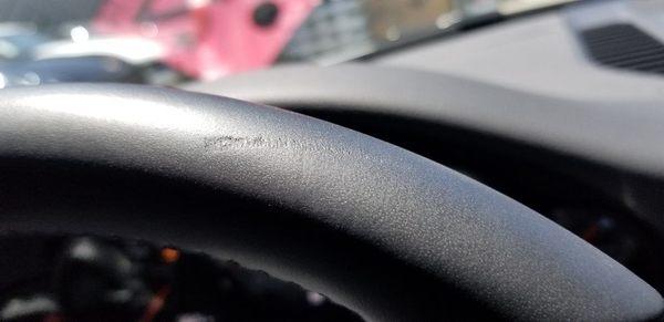 Before picture of damage to leather steering wheel.