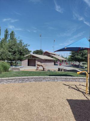 Bathrooms and a shaded area for sitting and eating in the background.