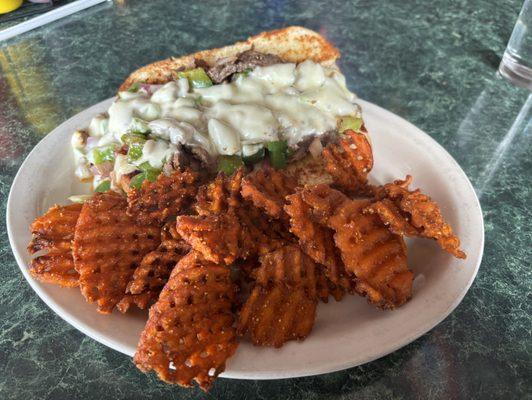 Philly cheesesteak sandwich and sweet potato fries