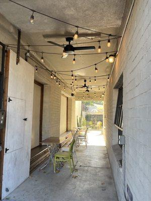 Outside walkway with some seating and shade