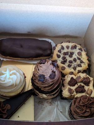 Mango passion fruit cupcake, eclair, the best chocolate chip cookie, peanut butter cookie and a chocolate cupcake