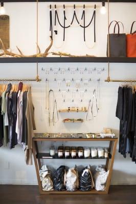 Shop wall showcasing jewelry, clothing, bags, candles, art, matchstick bottles, totes, etc. We have the perfect combo of gifts for all!