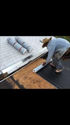 Base sheet being applied on flat az room roof