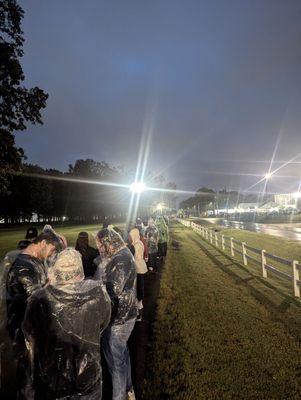 Line of people waiting in the rain with zero updates for hours